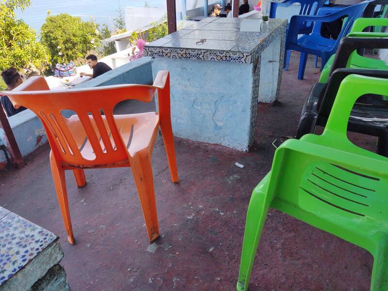 Crude block tables and cheap plastic chairs at Café Hafa in Tangier.