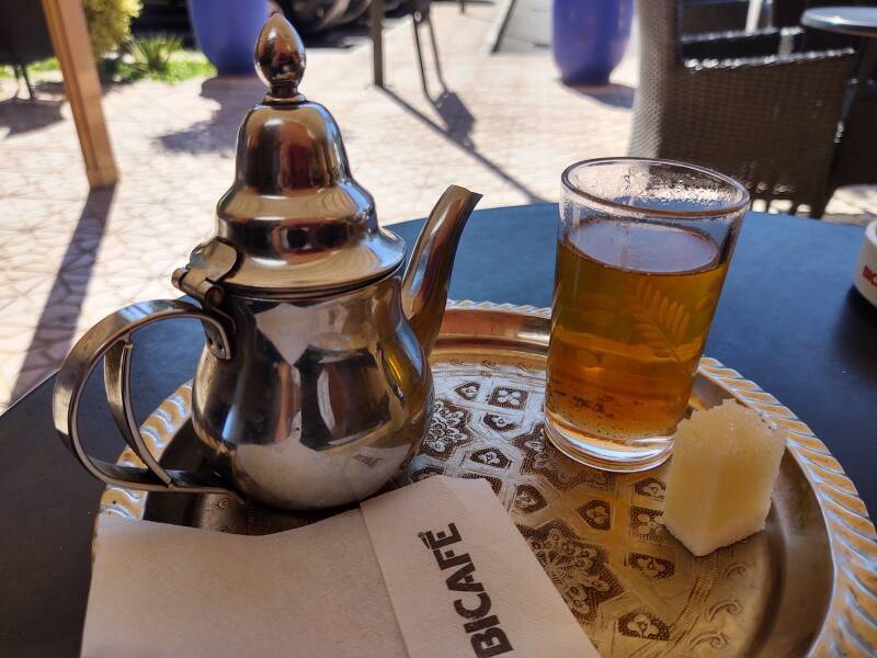 Shiny tea pot, small glass, and large block of sugar for mint tea before boarding the bus from Marrakech to Zagora.