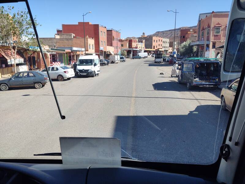 Businesses along the road in Agouim in the Atlas Mountains. A man crosses the road.