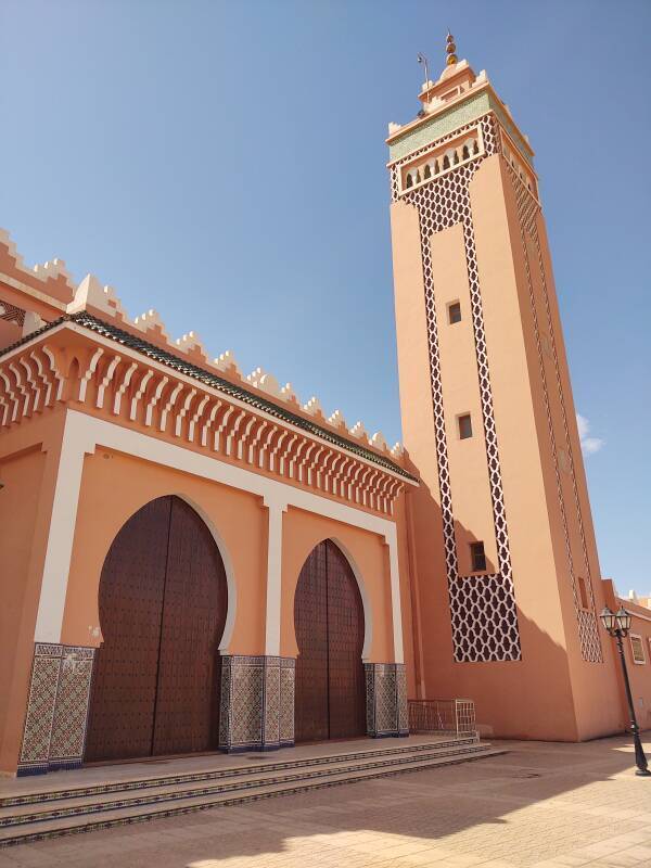 Minaret and large entry doors on main mosque in Zagora, Morocco.
