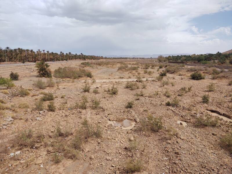 Dry bed of the Draa river with one small puddle.