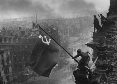 Soviet soldiers raise their flag over Berlin.
