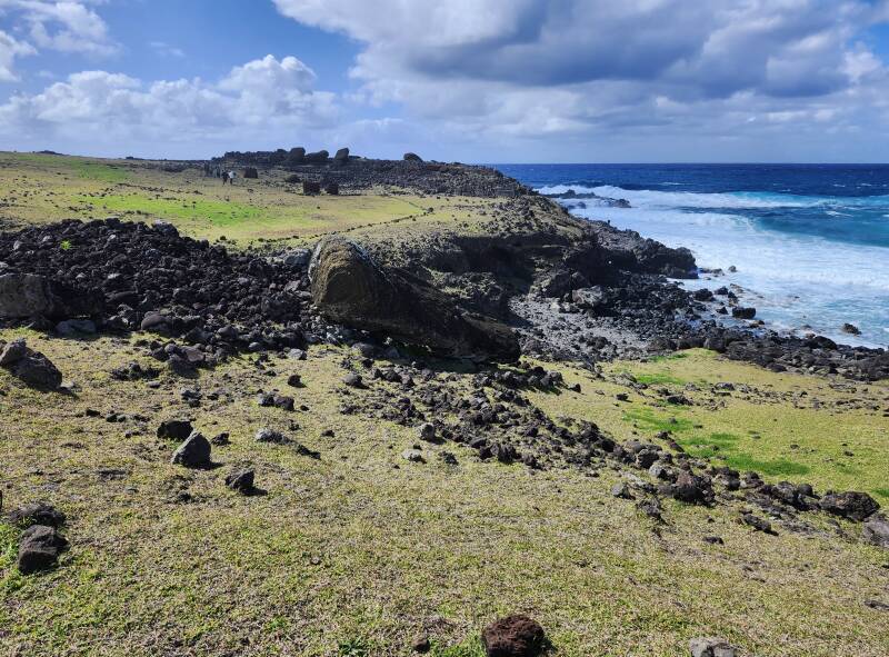 Mo'ai lying on its back near the shore.