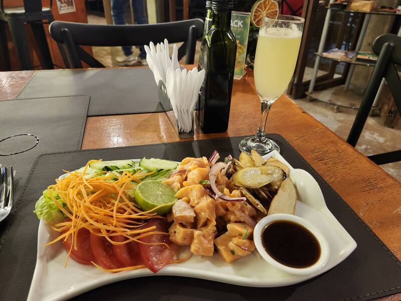 Salmon ceviche with salad and fried sweet potato slices.