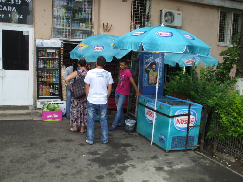 Busy snack kiosk outside apartment building near Bucureşti Gară de Nord train station in Bucharest, Romania.
