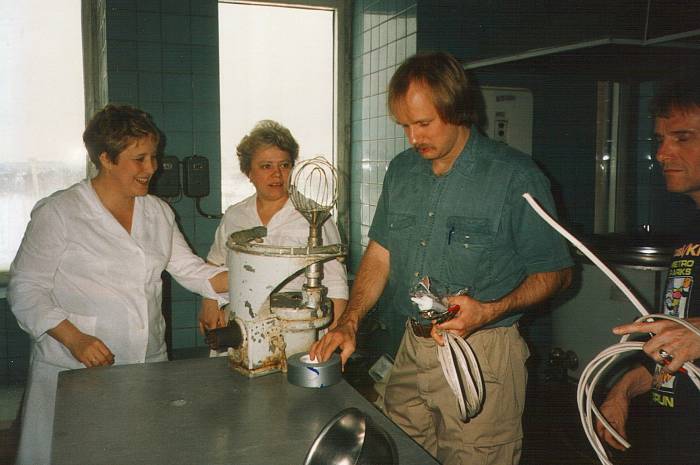 Working in a Russian hospital kitchen, repairing an industrial mixer.