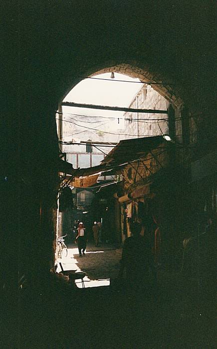 People walking through arched passageways in the bazaars in Aleppo, Syria.