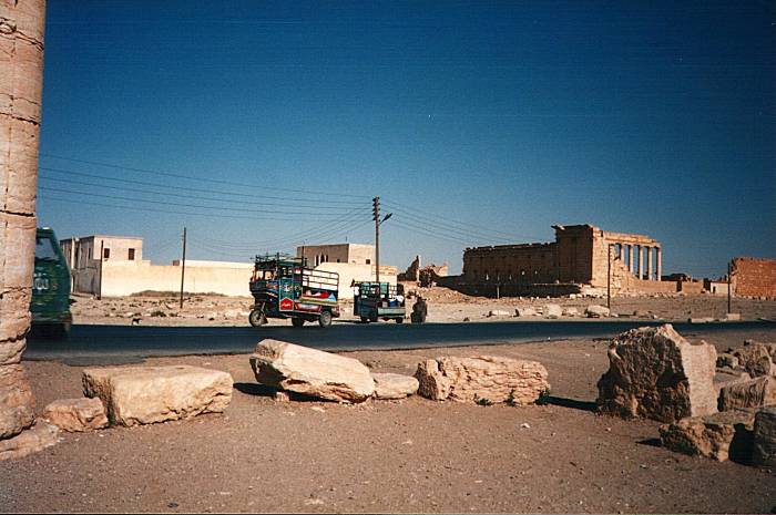 Three-wheel vehicle on the highway cutting across Palmyra near the Temple of Ba'al.
