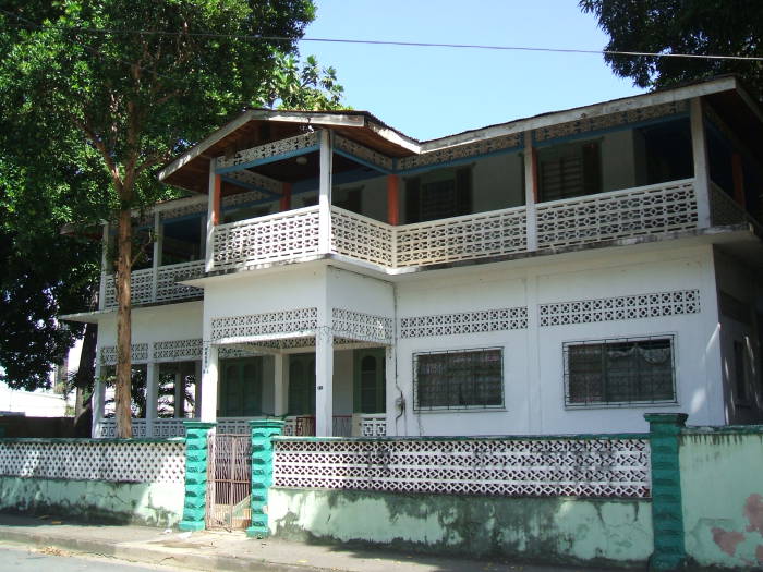 Pearl's Guesthouse in Port-of-Spain, Trinidad, a traditional boarding house beside a pleasant park.