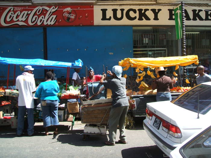 Downtown Port-of-Spain, Trinidad. Markets along the sidewalk in front of Lucky Bakery.