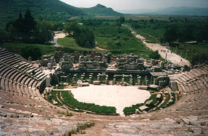 Ephesus: the Great Theatre and the harbor district as seen from the upper seats in the theatre.  Classic Greek architecture, now in ruins.