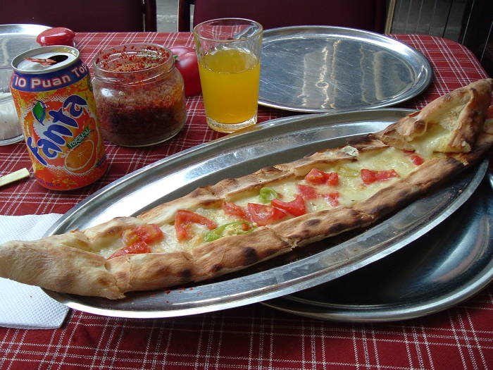 Turkish pide with tomatos and peppers.