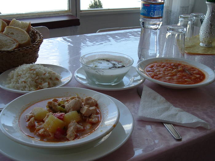 Turkish meal of stew, beans, plav, and cacik.