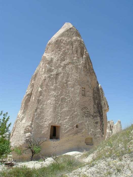 Large stone carved church in a free-standing tuff cone in Cappadocia, Turkey.