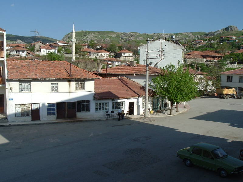 Main street in Boğazkale, Turkey.  Two tea houses, a dump trunk, and some homes.