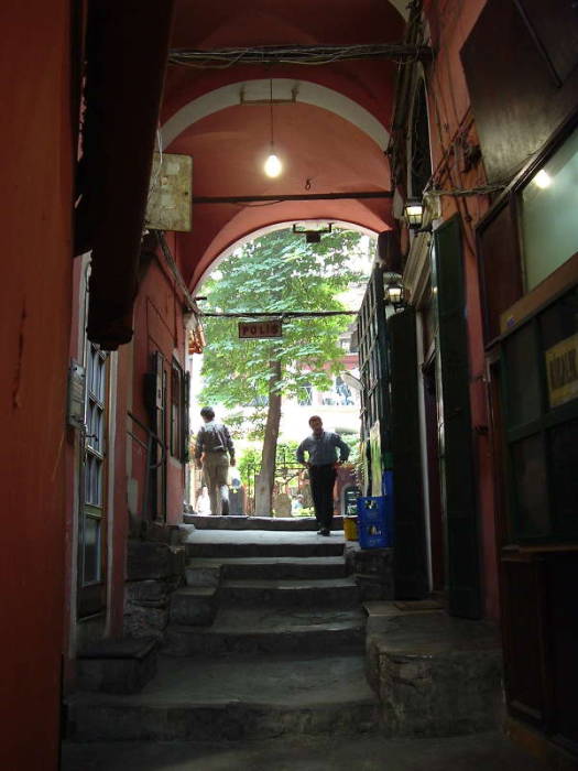 Passageway leading to Zincirli Han within the Grand Bazaar in Istanbul.  Steps leading up past a small tea shop to an open han.