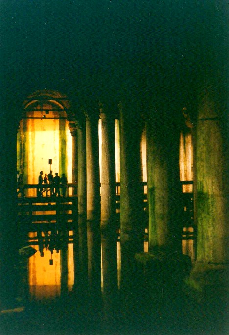 Basilica Cistern or Yerebatan Sarnıcı in Istanbul.  Large marble columns, shallow water, stone arches.