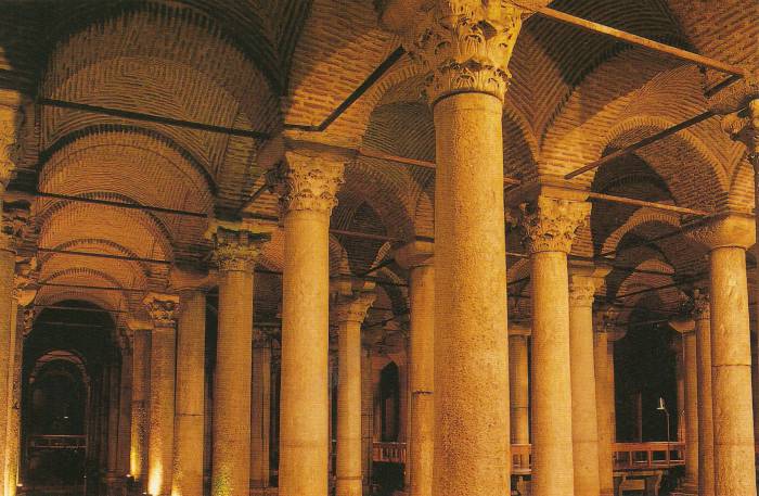 Basilica Cistern or Yerebatan Sarnıcı in Istanbul.  Large marble columns, shallow water, stone arches.
