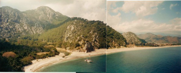 Panorama of the Olympos beach with mountains in the background.