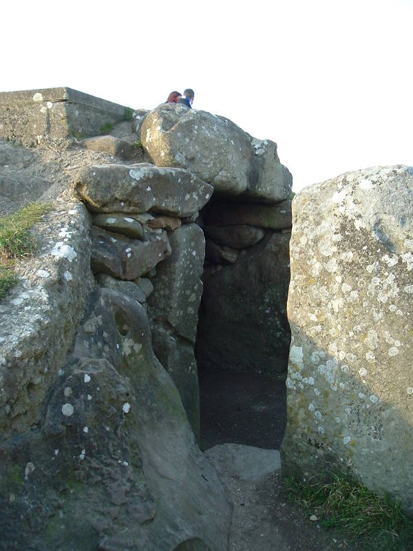 Large sarsen slabs guard the entrance of the West Kennet Long Barrow, an ancient tomb.