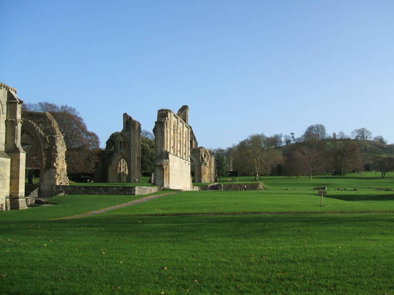 South exterior of Glastonbury Abbey and the Tor in the distance.