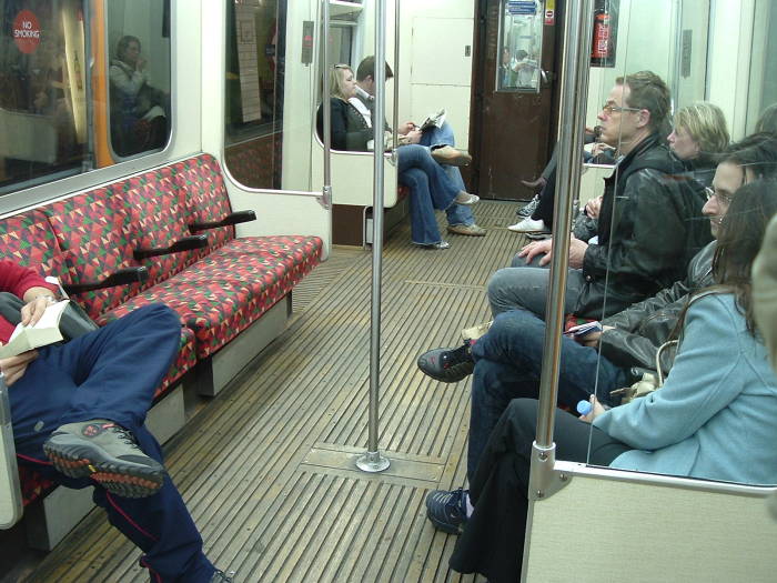 Interior of a London Underground train travel between  Tube stations.