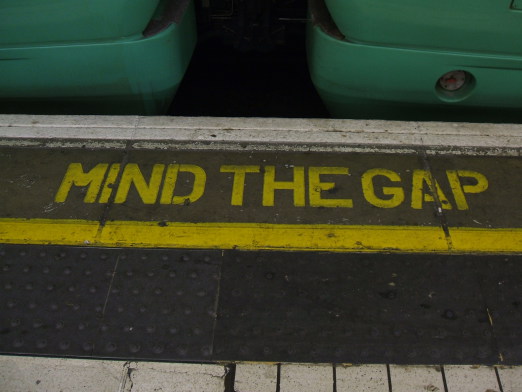 'MIND THE GAP' warning at the edge of the platform in a London Underground station.