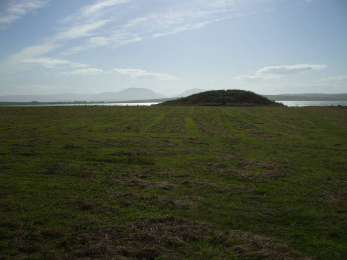Salt Knowe, a tumulus just outside the Ring of Brodgar, the hills of Hoy visible in the distance.
