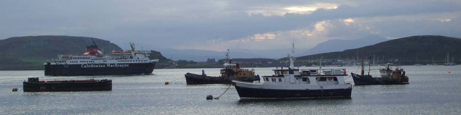 Hebredian ferry and fishing boats in the harbor at Oban, Scotland.