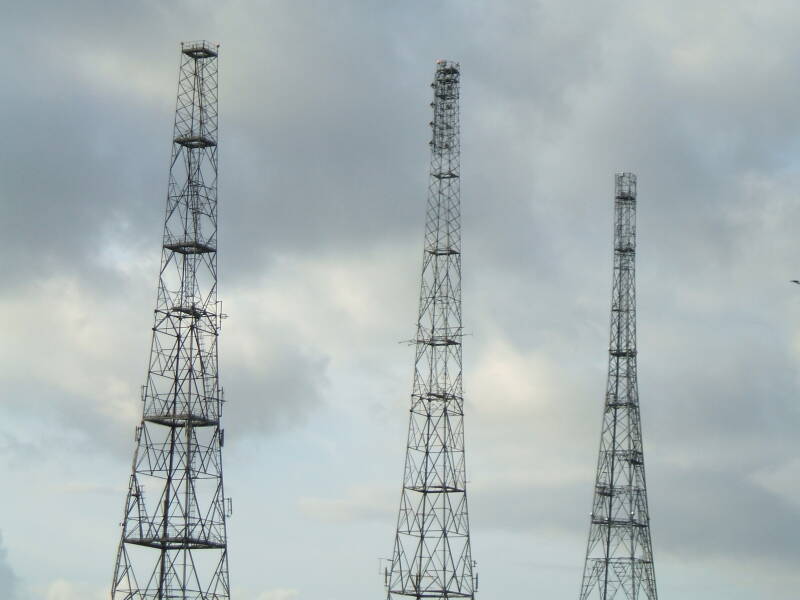 Chain Home WWII radar towers with modern UHF and microwave antennas.