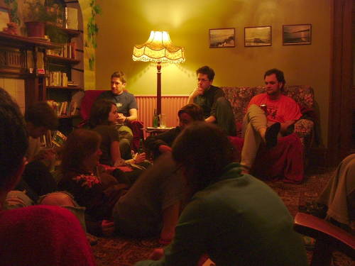 A group of travelers in the main parlor at Fort William Backpackers.