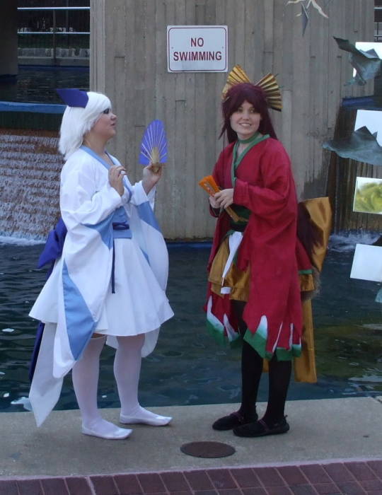 Anime girls being photographed at a fountain at the Otakon anime and manga conference in Baltimore.