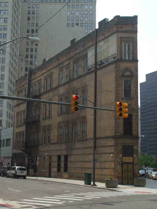 Narrow flatiron building near Wayne County building.