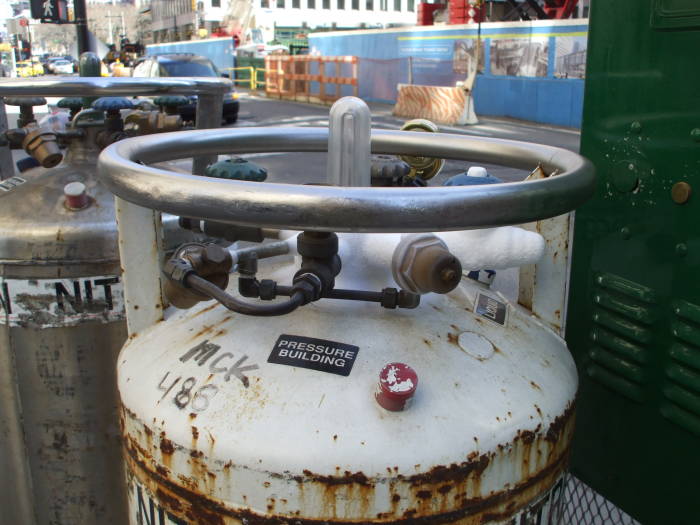 Moisture condenses and freezes on the plumbing on top of liquid nitrogen dewars along Broadway.