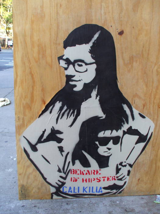 Stencil art of a hipster girl wearing a T-shirt bearing stencil art.  BEWARE OF HIPSTERS!