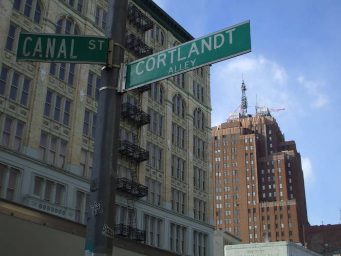 A street sign shows the intersection of Cortlandt Alley and Canal Street in Chinatown.