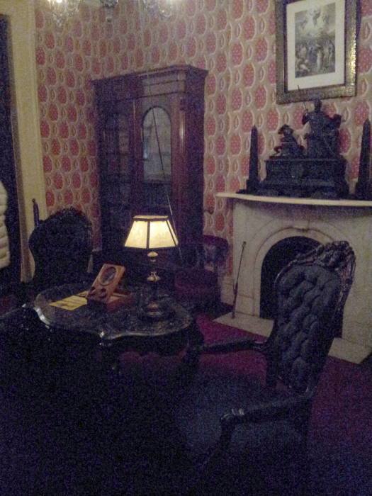 Library with gas lights and horsehair chairs within Theodore Roosevelt's birthplace in New York.
