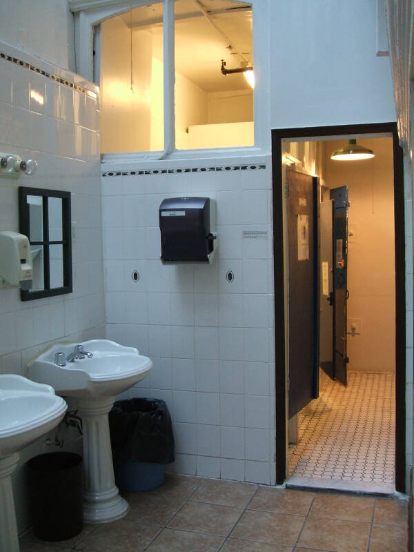 Shared bathroom: sinks, shower stall, toilet stalls.