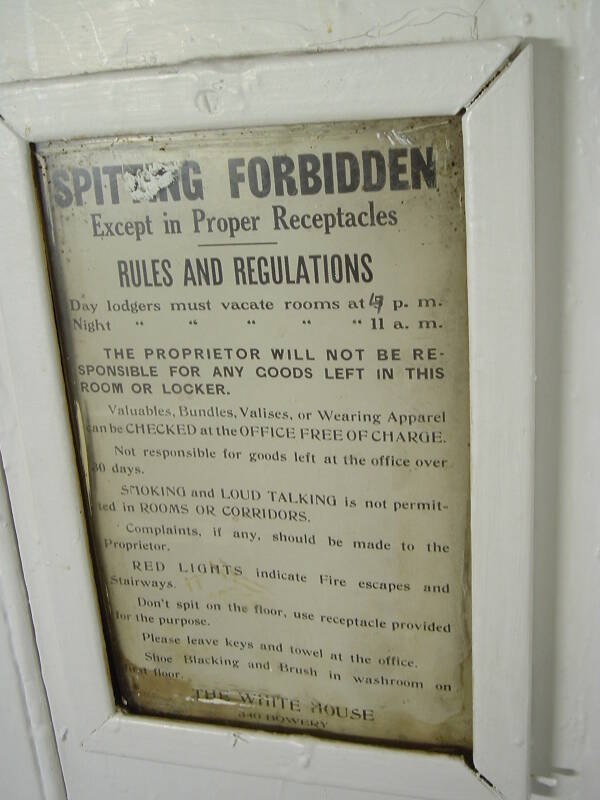 Sign in the hallway of the Whitehouse SRO hotel and hostel.