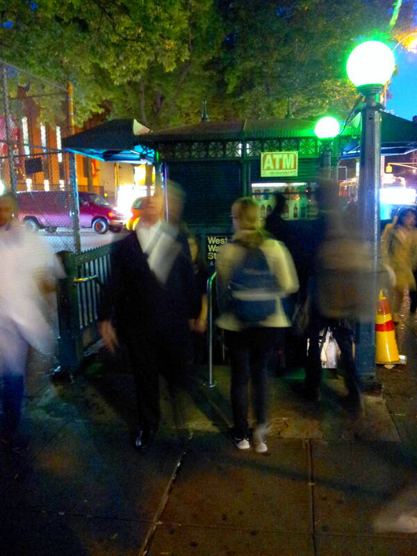 Blurred people entering and exiting the West 4th Street Washington Square Station on the New York MTA.