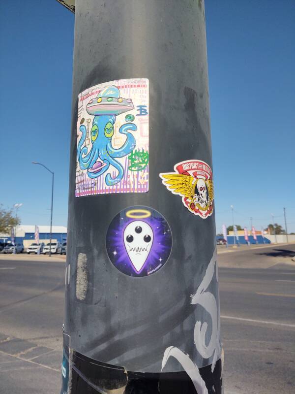 Extraterrestrial-themed stickers on a light pole in Roswell, New Mexico