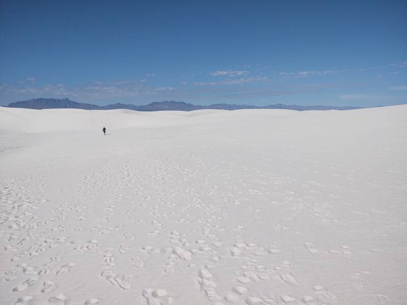 Man walking into the dunes at White Sands.