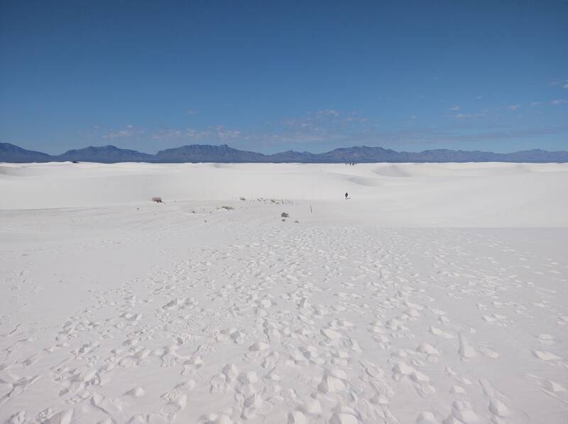 People walking into the dunes at White Sands.