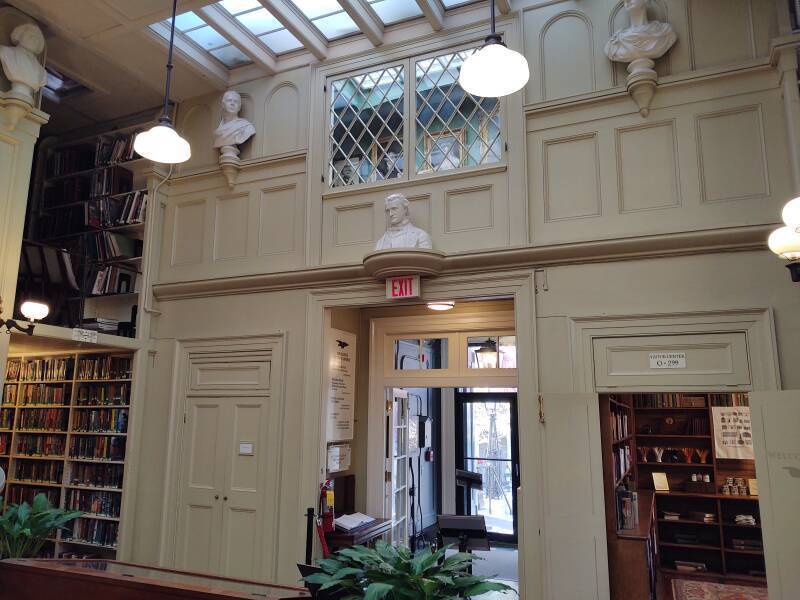 Bust of Edgar Allan Poe above the entrance, and above that, daguerreotype of Poe and painting of Whitman in the Providence Athenæum.