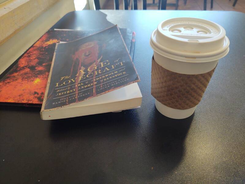 Coffee and the book 'The Age of Lovecraft' at the Blue State Coffee Shop in Providence, near the Brown University campus.