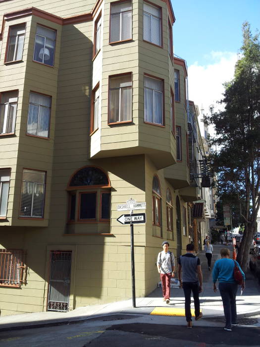 People cross the narrow street at Dashiell Hammett Way in San Francisco.