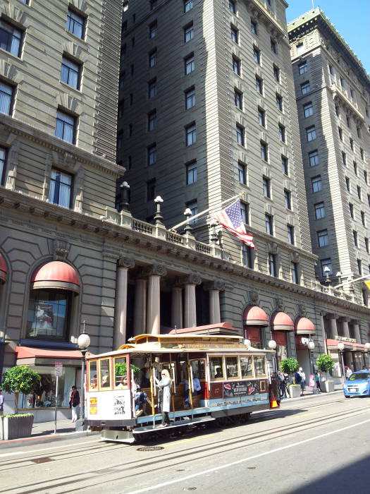 A cable car passes the front of the Saint Francis Hotel, the model for Miss Wonderly's hotel the Saint Mark Hotel in San Francisco.